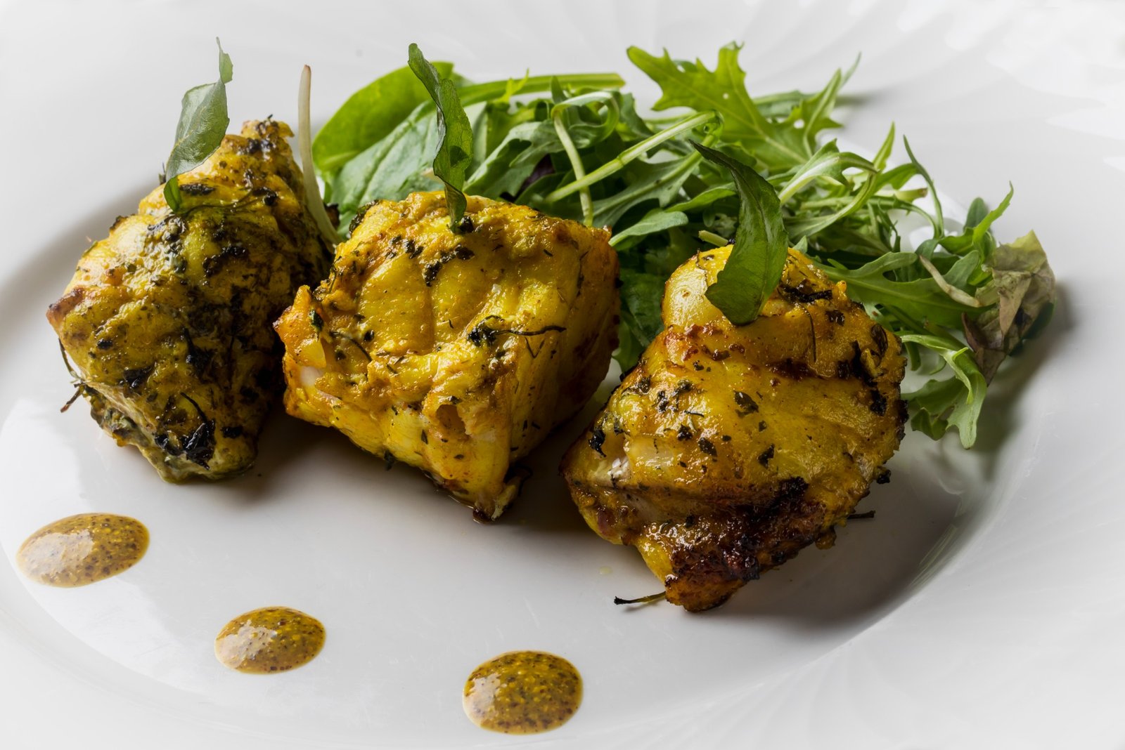 Tandoor-smoked dish served with fresh leaves